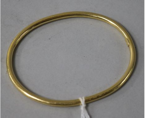 A Tiffany & Co 18ct gold bangle.