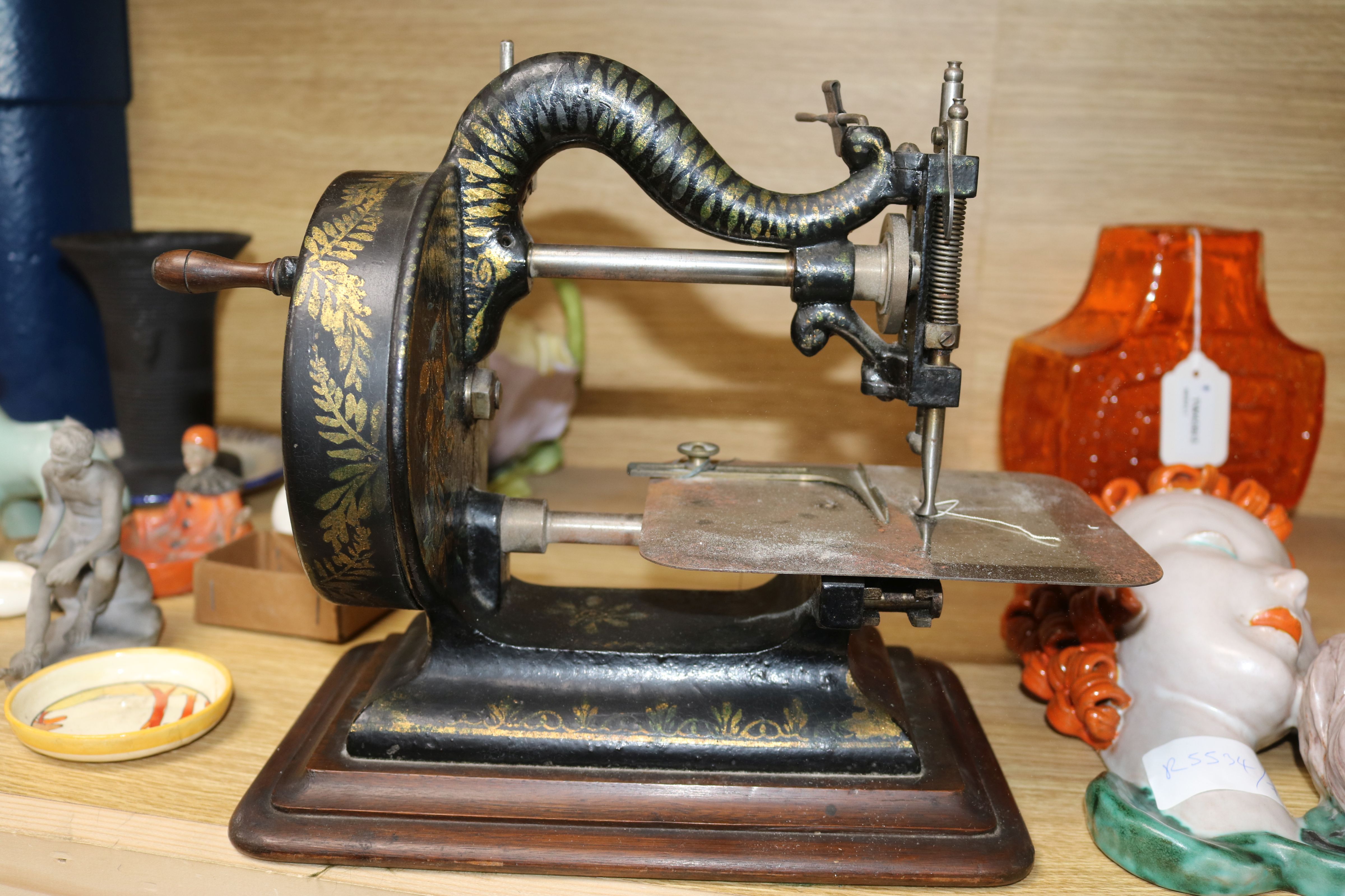 A Victorian Newton Wilson & Co sewing machine, with contemporary manual