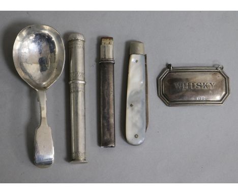 A Victorian silver caddy spoon, a silver whisky label, a Norwegian needlecase, a silver and mop fruit knife and a silver penc