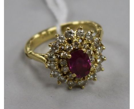 A yellow metal, ruby and diamond cluster ring, size K.