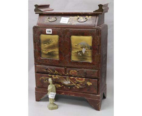 A Japanese lacquered table cabinet and a bowenite carving of Kwan Yin (2)