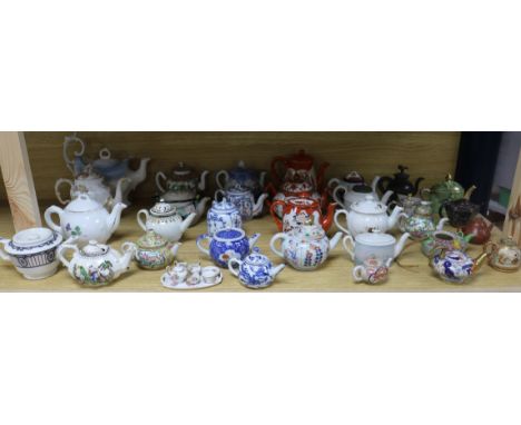 A large collection of ceramic teapots including German, Staffordshire, Cantonese, etc.