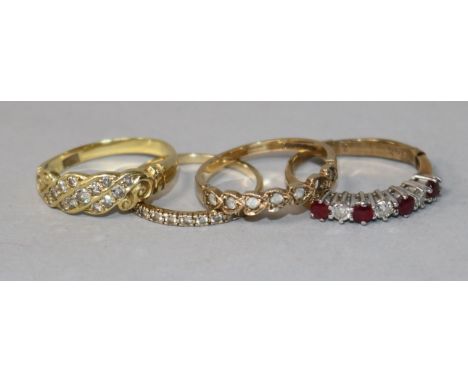 A ruby and diamond half-hoop ring, a diamond-set 18ct gold ring and two other rings.