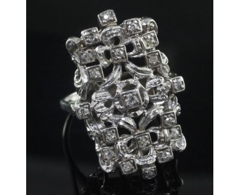 An 18ct white gold and diamond set modernist dress ring, of free form rectangular design, size V.