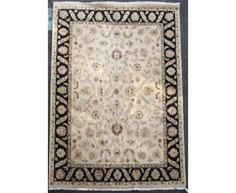 A Tabriz style carpet, with field of palmette scrolls on a beige ground, 12ft 2in. x 9ft 1in.
