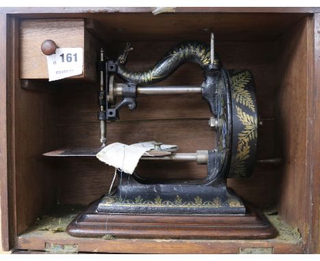 A Victorian Newton Wilson & Co sewing machine, with contemporary manual