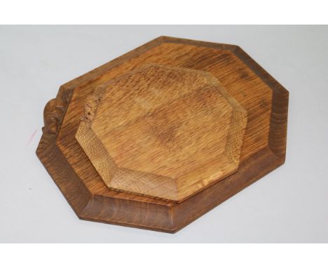 A Robert 'Mouseman' Thompson octagonal bread board with signature mouse and a similar pot stand W 30cm & 19cm