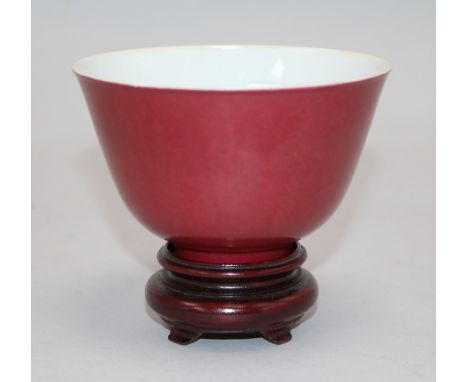 A Chinese ruby ground cup, wood stand Bowl 6.5cms H