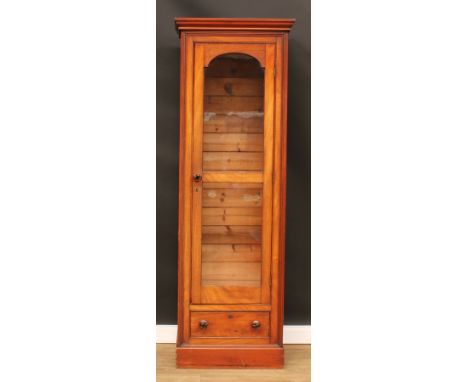 A Victorian mahogany and pine cabinet, moulded cornice above a glazed door and a drawer, plinth base, 199.5cm high, 67cm wide