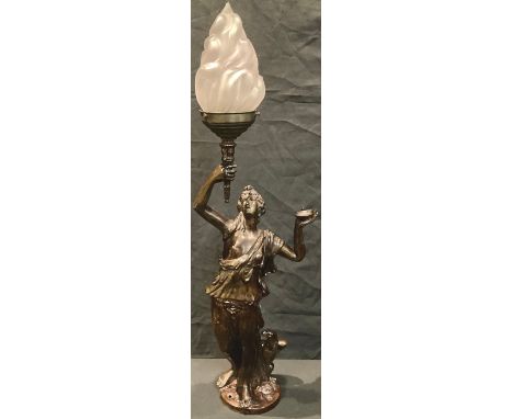 A bronzed spelter table lamp modelled as a classical maiden holding torch aloft, frosted glass shade, 71cm high 