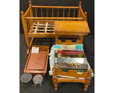 A doll's crib; a doll's three poster type bed; a bagatelle game; a "Go Fish" game; a coin bank 