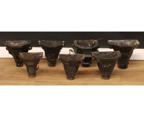 A harlequin suite of seven late 19th/early 20th century iron rainwater hopper heads, the largest 27cm high, 30cm wide, 21.5cm