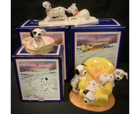 A Royal Doulton Disney 101 Dalmatians model, Pups in the Armchair, DM11, 10cm high, boxed; two others, Lucky and Freckles on 