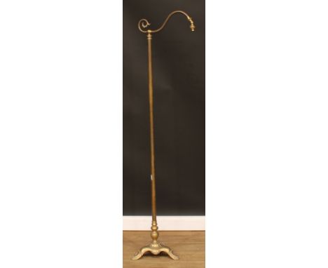 A brass swan neck floor lamp, triform base, stylised paw feet, 169.5cm high 