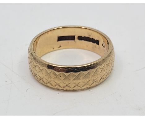 A 9ct. textured gold band, size UK K 1/4. (4.0g)  