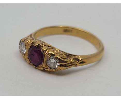 An 18ct. gold, ruby and diamond ring, set central mixed round cut ruby and round brilliant cut diamond to either side, with s