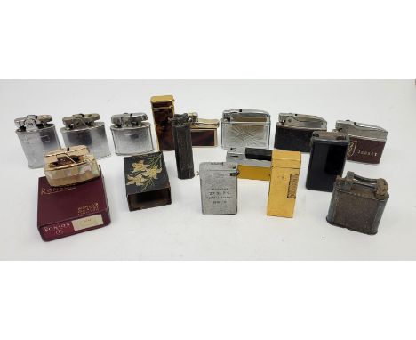 An engine turned yellow metal Dunhill Rollagas lighter, stamped "U.S.RE.24163 Patented", together with two other Dunhill ligh
