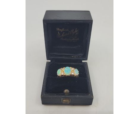 An 18ct. gold, opal and diamond ring, Birmingham 1912, set three graduated oval cabochon opals highlighted by four old-cut di