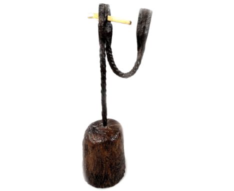 A 18thC wrought iron rush light, with a single wrought iron twisted candle arm, on a tapering wooden base, 30cm H.