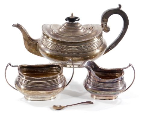 A George V silver tea set, of three pieces of earlier Georgian design and of swollen rectangular design with gadrooned border