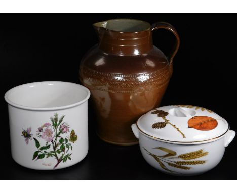 A 19thC brown stoneware jug, with beak spout, strap work handle and upper floral banding, with inverted body, unmarked, 35cm 