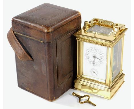 A 19thC French brass carriage clock, the rectangular case with swing handle, on a stepped base terminating in compressed feet