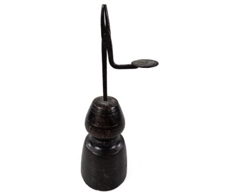A late 17thC/early 18thC wrought iron rush light, with cylindrical platform, on turned wooden base, 33cm H.