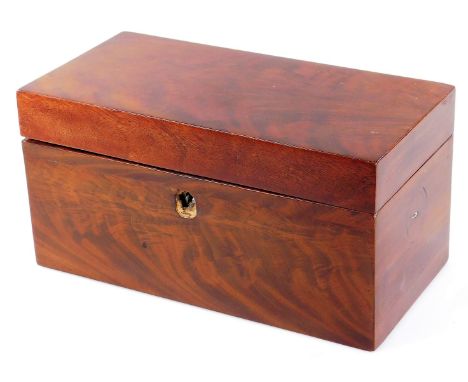 An early 19thC mahogany tea caddy, of rectangular form, with fitted interior centred by a mixing bowl, flanked by two lidded 