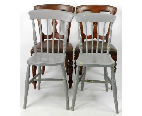 A pair of Edwardian walnut dining chairs, each with hour glass splats, centred by a flowerhead patera, above overstuffed seat