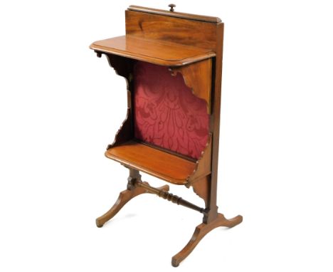 An early 20thC mahogany drop leaf firescreen, with two shelves and embroidered style back, on angular legs terminating in com