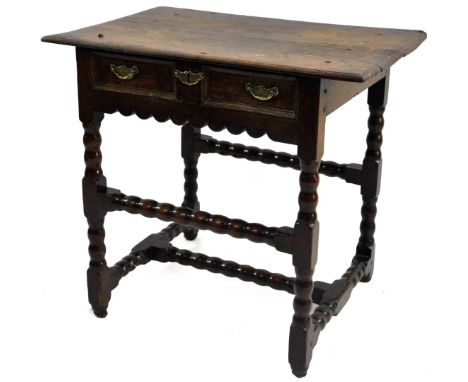 A late 17thC/early 18thC oak side table, the rectangular top with a moulded edge above a single panelled frieze drawer with b