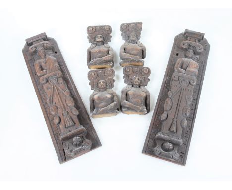 A pair of late 17thC/early 18thC carved oak caryatids, each with a cloak draped over their shoulder, on a tapering base, 40cm