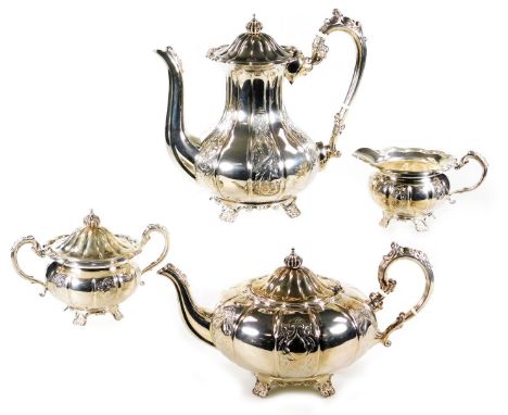 An Elizabeth II silver four piece tea and coffee set, of fluted urnular design, with chased flowerhead knops and foliate deco