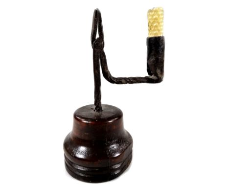 A late 17thC/early 18thC wrought iron rush light, the candle arm with twisted decoration on a turned wooden base, 20cm H.