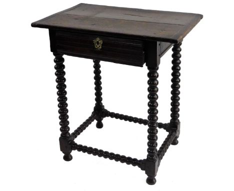A late 17thC/early 18thC oak side table, the rectangular planked top with cleated ends above a frieze drawer with bobbin turn