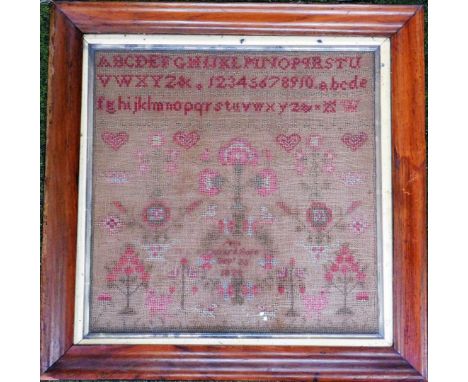 A 19thC needlework sampler, by Ann Ward, born September 25th 1822, with alphabetical and numerical cross stitch and floral su