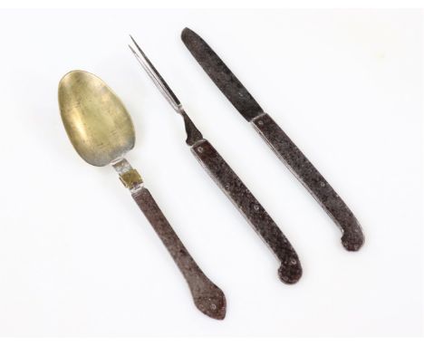 A rare 17thC steel and brass three piece folding travelling or campaign knife, fork and spoon set, the handles with hatched a