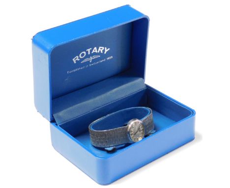 A silver Rotary ladies wristwatch, with oval circular watch dial, and winder set with blue stone, on bark effect etched brace