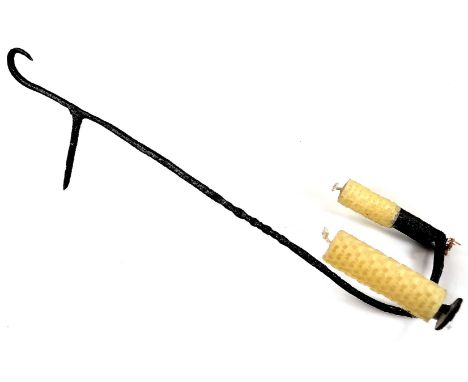 A hanging rush light, with two candle arms, one a socket, the other a pricket fixing, 40cm H.