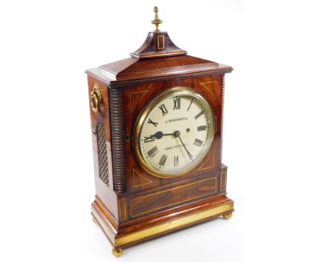 J Brunskill, Cheltenham.  An early 19thC rosewood bracket clock, in a rectangular case surmounted by an urn finial with gilt 