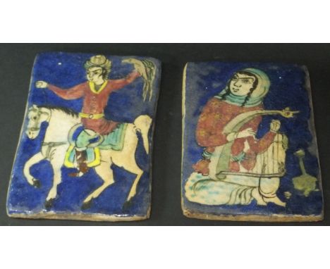 Two Quajar Persian tiles of rectangular form, one depicting a falconer on horseback, the other depicting a harp player, 21.5 
