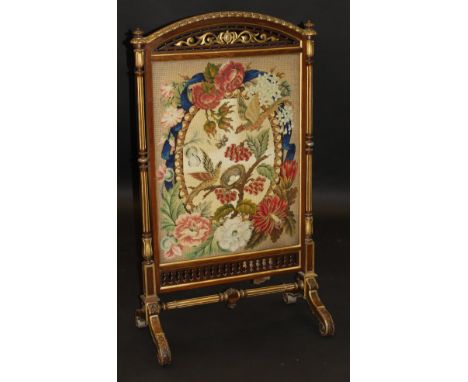 A Victorian mahogany and gilt framed firescreen, the central needlework panel depicting exotic birds and nest of eggs with bu