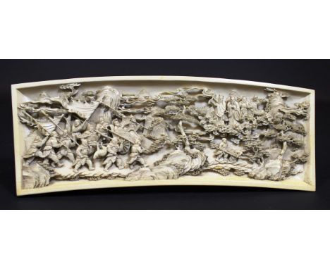 A 19th Century Japanese Meiji period carved ivory panel of slightly curved form depicting a hunting party with quarry and dei