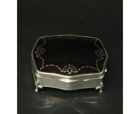 A silver and tortoiseshell mounted dressing table trinket box of shaped rectangular form raised on four scroll feet (by Mappi