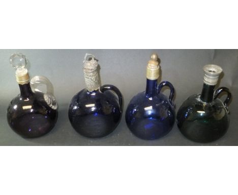 Four various 19th Century coloured glass flagons - two Bristol blue, one amethyst and one green, height of tallest flagon 18.
