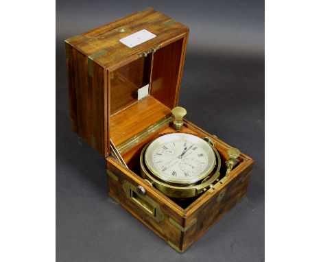 An early 20th Century brass cased ship's chronometer by Dent of London, No'd. 7692, the silvered dial with Roman numerals enc