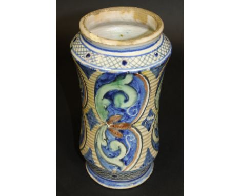 A late 18th Century Sicilian Maiolica albarello of simple waisted form with foliate decorated panels raised on a circular foo