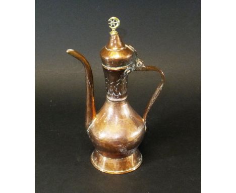 A 19th Century Turkish copper coffee pot with a small brass finial star enclosed by crescent moon, 23.5 cm high