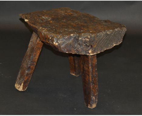 A 19th Century walnut pig bench on three simple legs, 81 cm x 60 cm