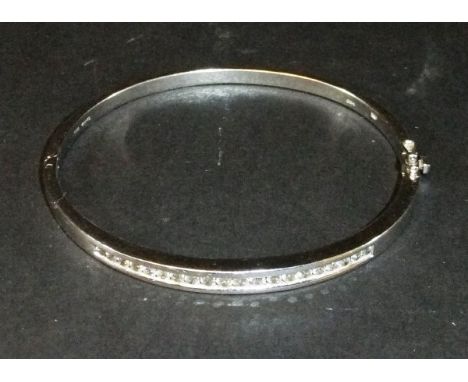 A 9 carat white gold bangle set with 20 small diamonds, approx 0.5 carats total
